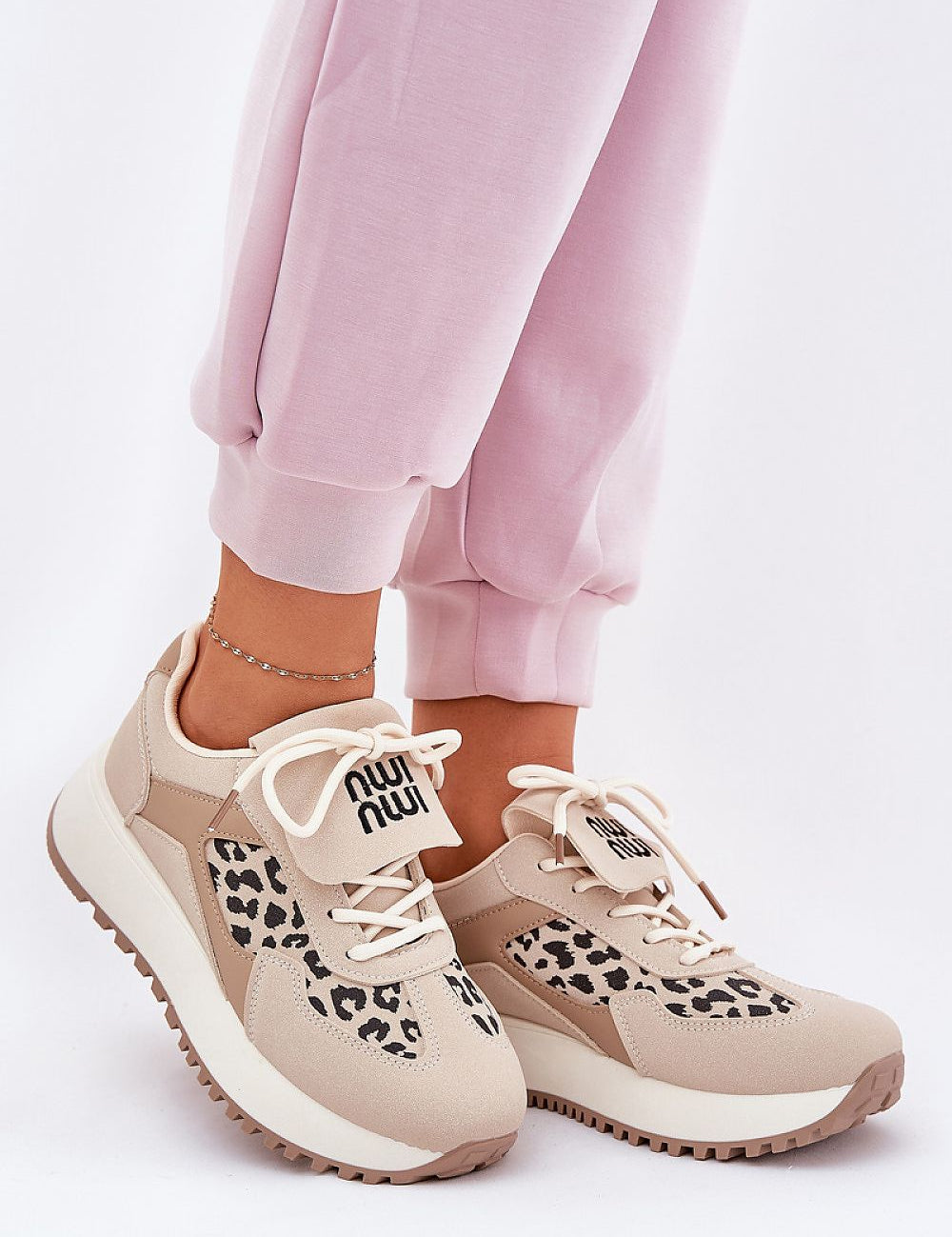 Person wearing Olivelle Wrapped Front Platform Shoes with suede-textured upper and subtle slogan, styled for casual comfort and daily walks.