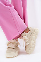 Beige Vernesse Elevated Leather Sport Shoes with thick laces and 5.5 cm platform sole, paired with pink pants for a bold style.