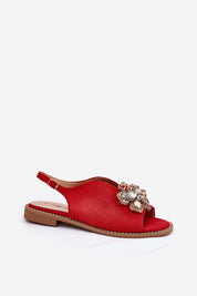 Red Fiorenna flat suede flower sandals with sculpted flower accent and adjustable ankle strap, ideal for everyday wear.