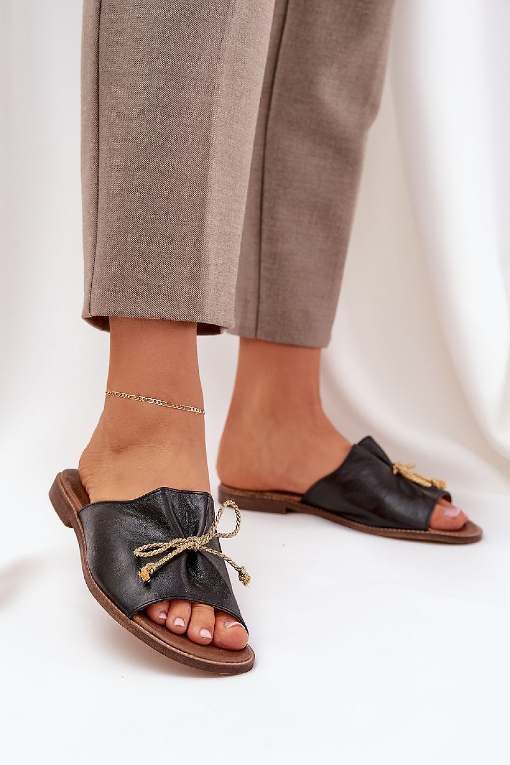 Black Veletta Soft Bow Sandals with ruched leather upper and flat heel, perfect for summer outfits and casual elegance.