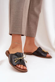 Black Veletta Soft Bow Sandals with ruched leather upper and flat heel, perfect for summer outfits and casual elegance.