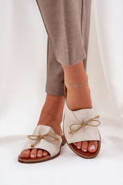 Veletta Soft Bow Sandals with delicate bows and ruched leather upper in natural off-white, perfect for summer elegance and comfort.