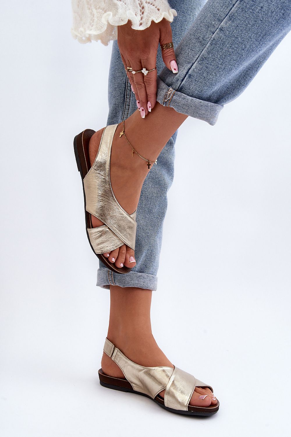 Woman wearing Talmea Soft-Strap Leather Sandals with open heel and toe, showcasing minimal design and comfort with denim jeans.
