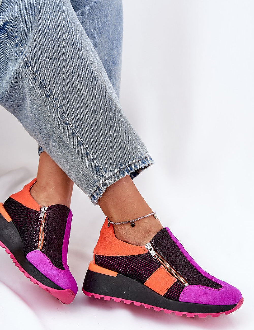 Woman wearing Averielle Wedge Zip Sport Shoes in vibrant colors, featuring dual zippers and a sculpted wedge sole for style and comfort.