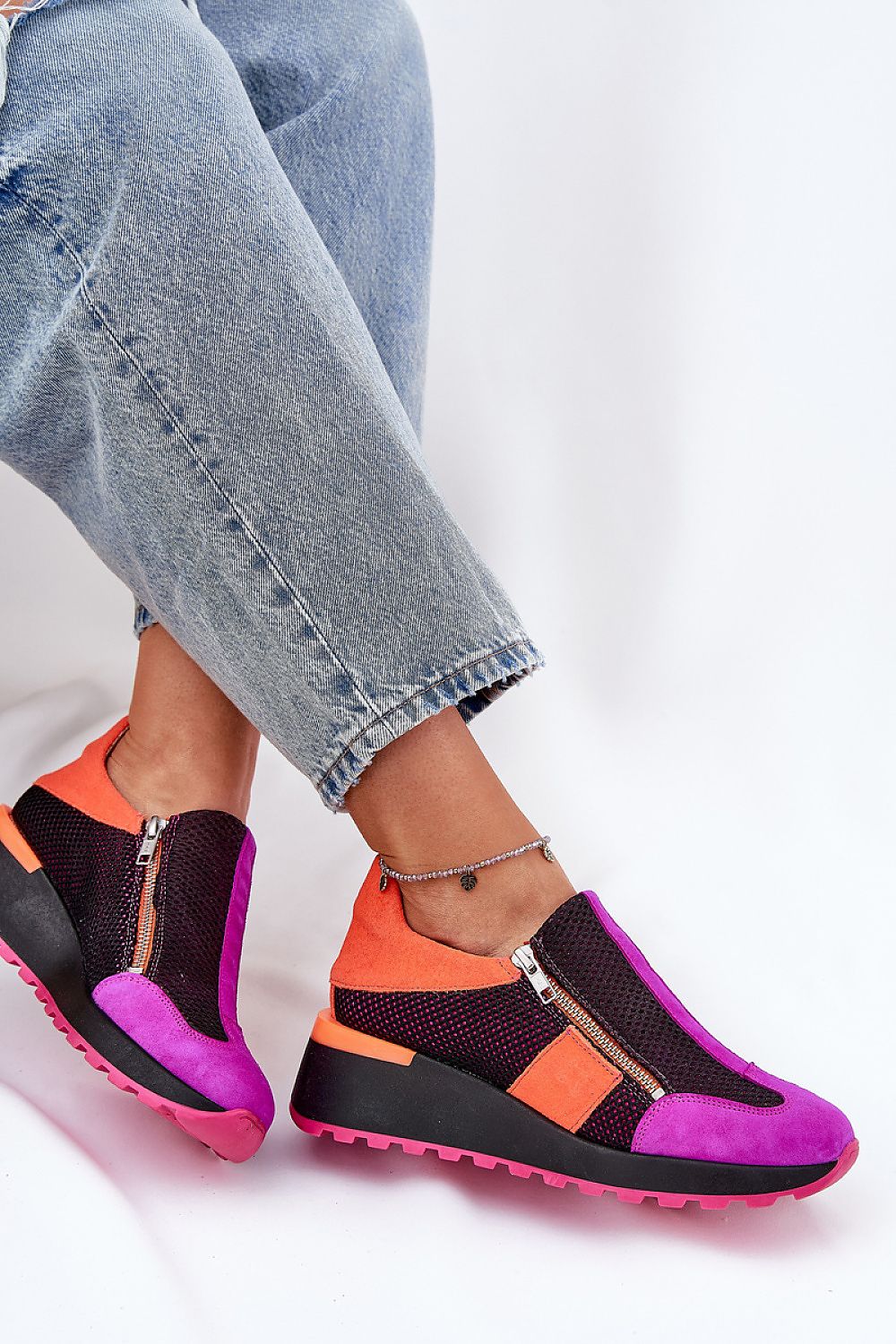 Woman wearing Averielle Wedge Zip Sport Shoes in vibrant colors, featuring dual zippers and a sculpted wedge sole for style and comfort.