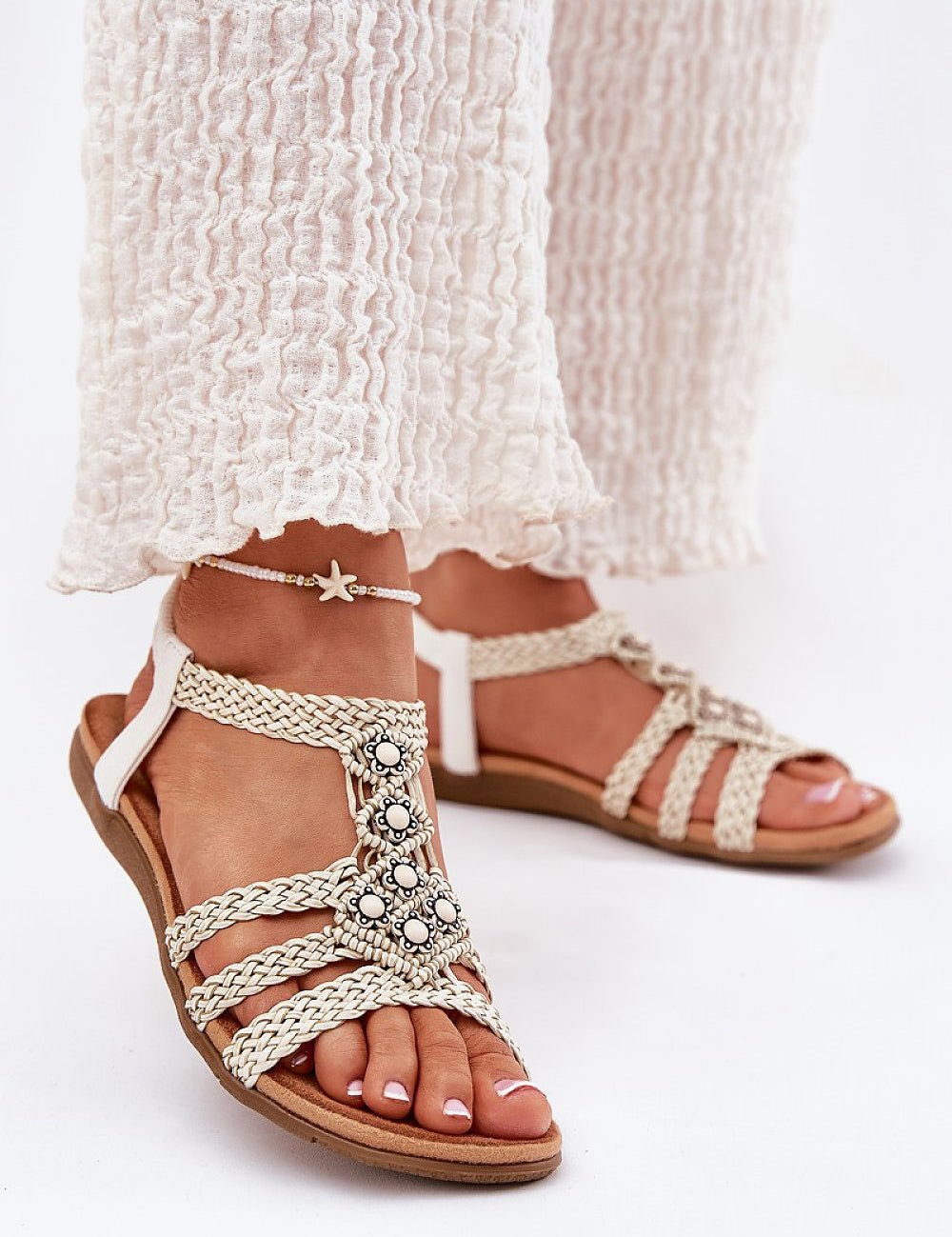 Ynessa braided flat summer sandals with faux leather straps, metallic accents, and a suede-like insole for comfort and style.