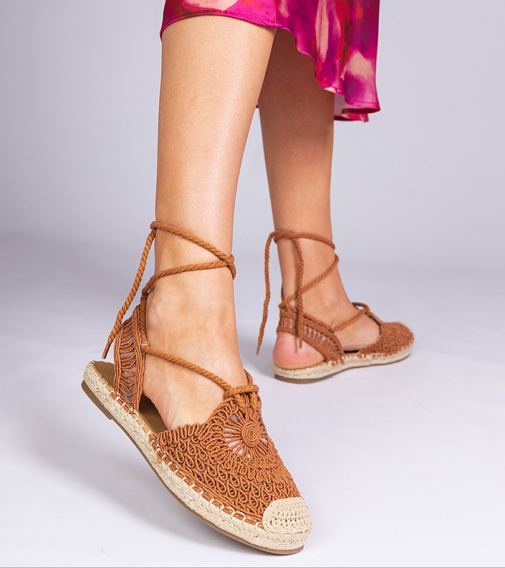 Woman wearing Serella Espadrille Sandals with braided sole, showcasing side and back tied design.