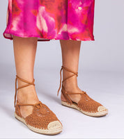Woman wearing Serella Espadrille Sandals with braided sole, paired with a vibrant pink dress, showcasing casual summer style.