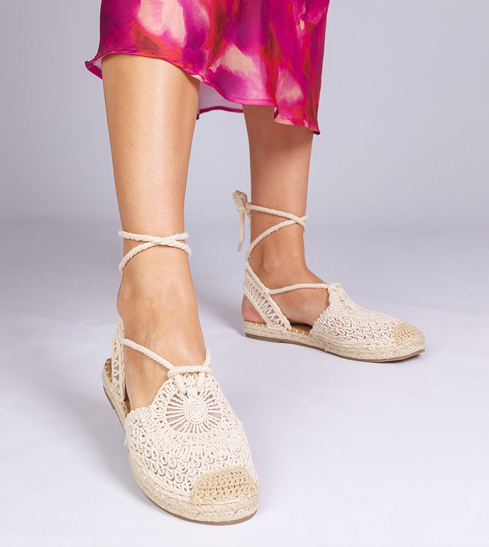 Woman wearing Serella Espadrille Sandals with braided sole, showcasing lightweight fabric and Mediterranean design.