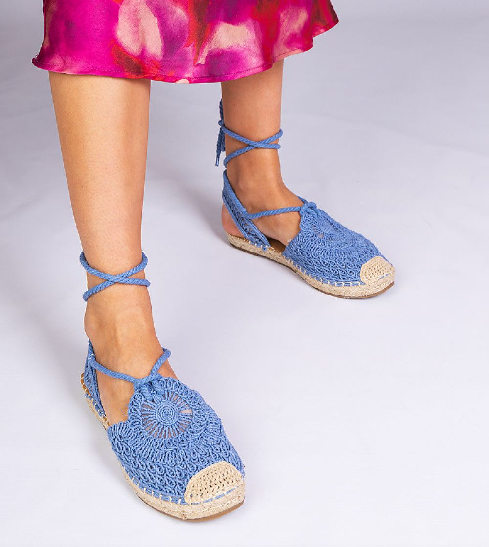 Blue Serella espadrille sandals on braided sole, perfect for summer; shown with colorful sundress.