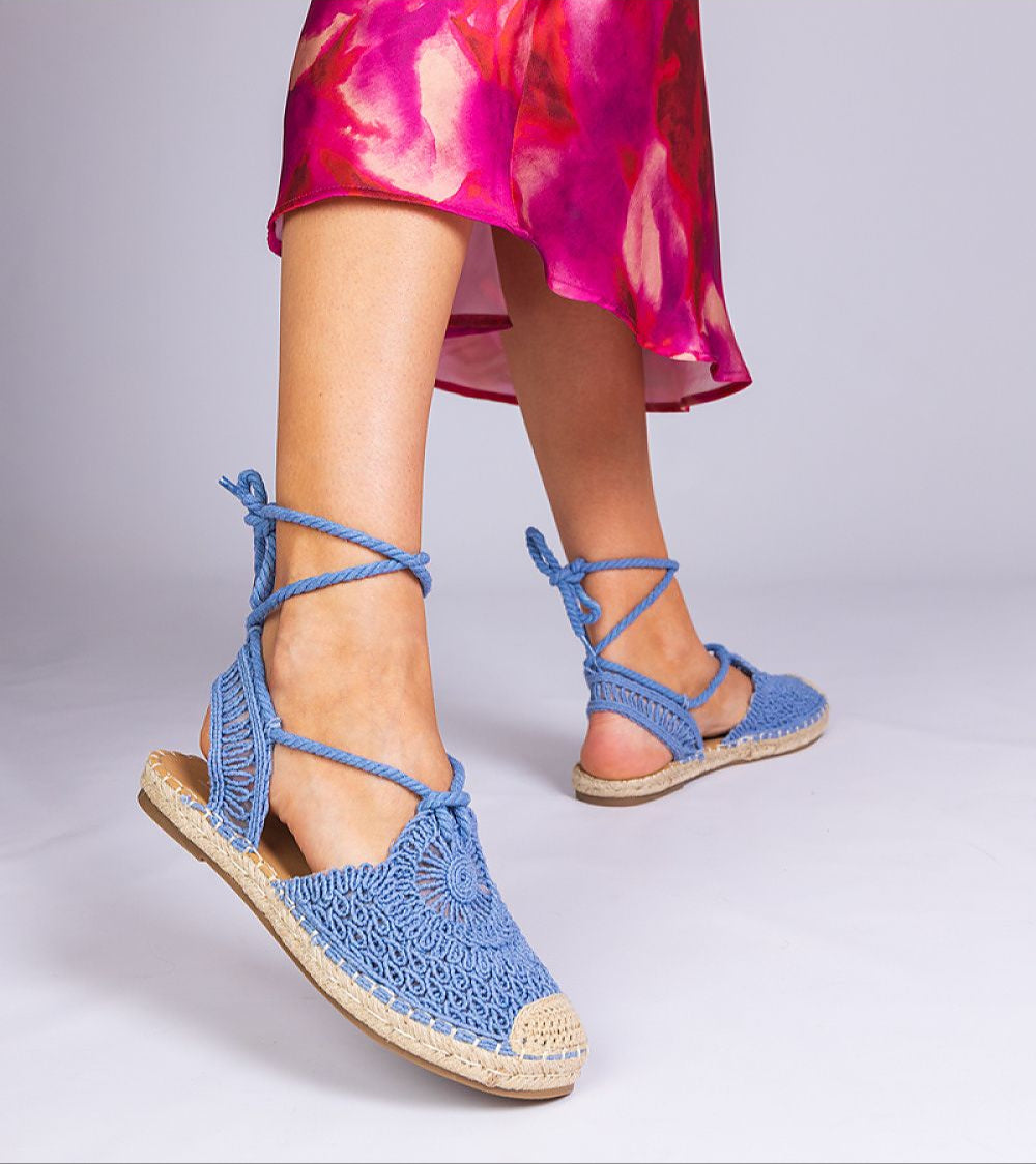 Woman wearing Serella Espadrille Sandals with braided sole and textile upper, styled with a colorful dress for summer fashion.