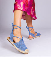 Woman wearing Serella Espadrille Sandals with braided sole and textile upper, styled with a colorful dress for summer fashion.