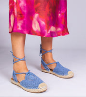 Blue Serella Espadrille Sandals on braided jute-effect sole, paired with a vibrant pink dress, perfect for summer fashion.