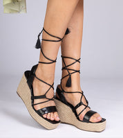 Black Nyrella High Wedge Espadrilles with braided jute soles and eco leather straps, featuring adjustable ankle ties for a secure fit.