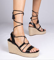 Black Nyrella high wedge espadrilles with eco leather straps and braided jute platform, perfect for summer style.