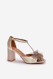 Gold leather column heel sandal with decorative front accent and adjustable strap, perfect for elegant occasions.