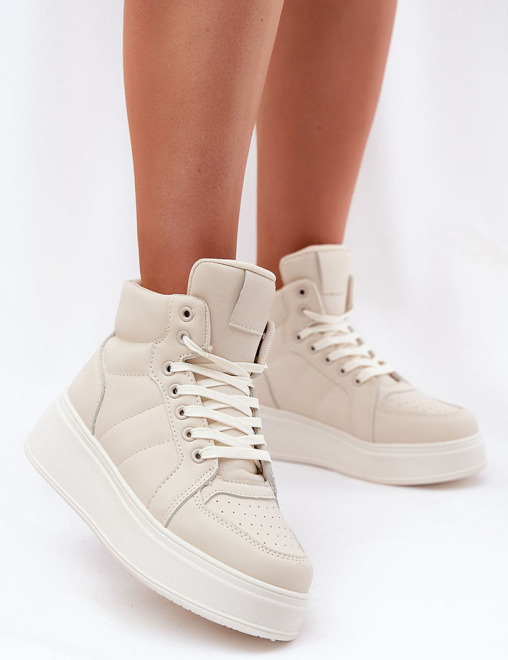 Woman wearing Cavora Platform High-Top Sneakers in smooth eco leather with 4 cm platform and 10 cm upper for a modern, stylish look.