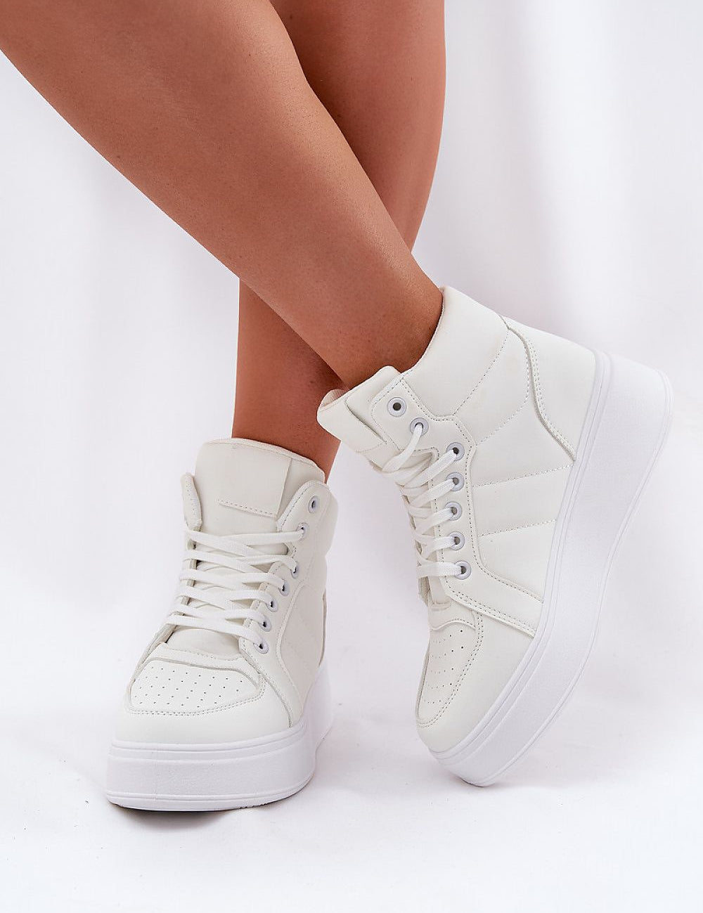 Woman wearing Cavora Platform High-Top Sneakers in smooth eco leather with 4 cm platform, showcasing sleek, modern design and secure fit.
