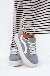 Ravelin suede platform sneakers in soft gray eco-suede with a white sole, showcased with a striped skirt for a chic casual look.