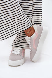 Ravelin suede platform sneakers with a pink stripe, worn with striped trousers, featuring eco-suede and supportive sole.