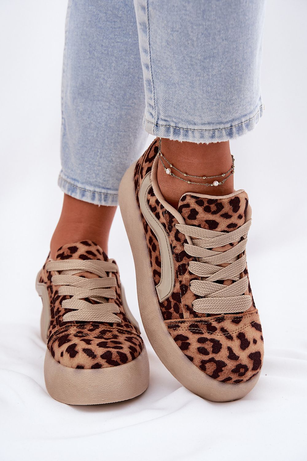 Leopard print platform sneakers with soft eco-suede, styled with light blue jeans, showcasing a chic casual footwear option.
