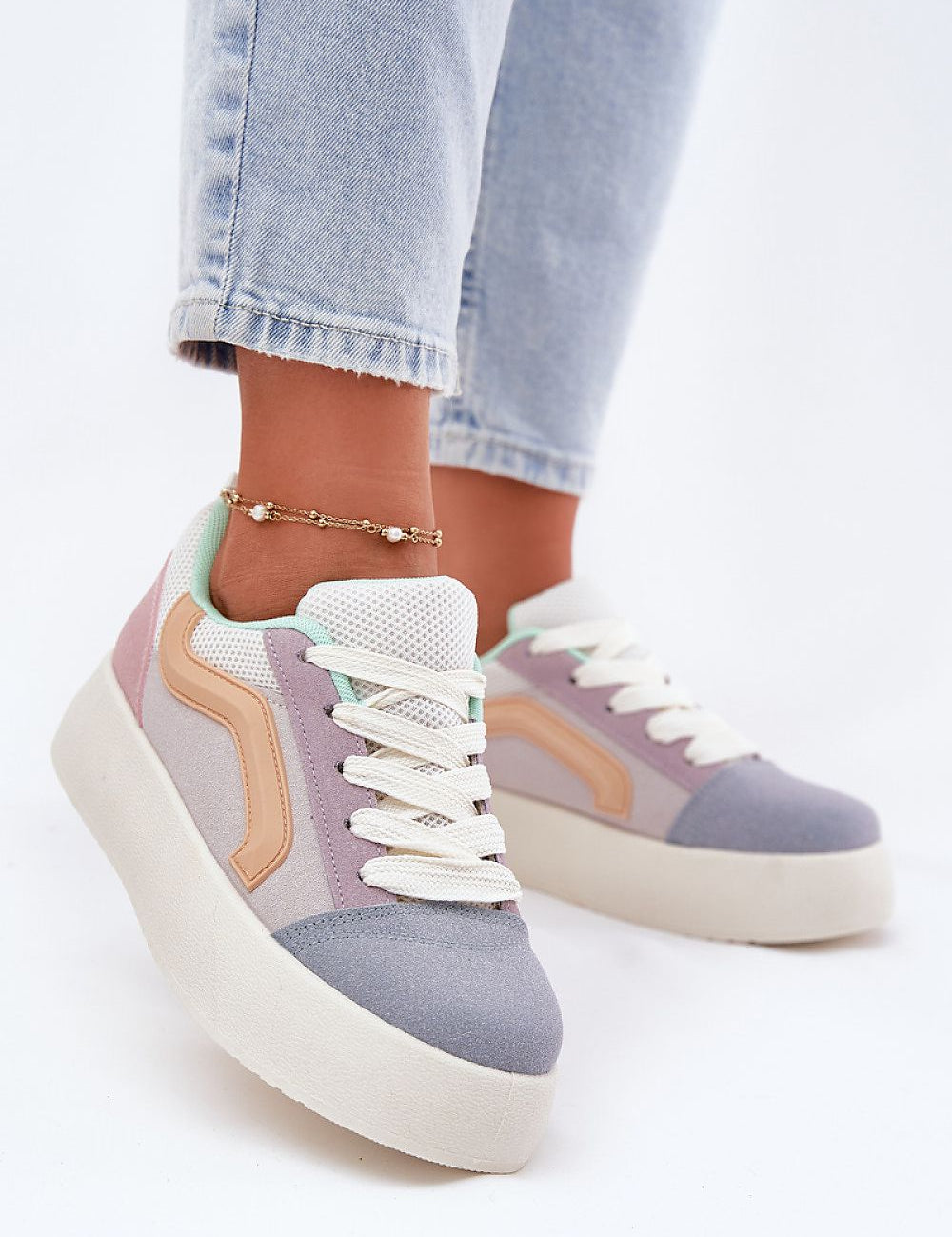 Person wearing Ravelin Suede Platform Sneakers with pastel design, showcasing eco-suede material and stylish platform sole.