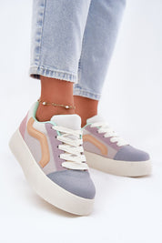 Person wearing Ravelin Suede Platform Sneakers with pastel design, showcasing eco-suede material and stylish platform sole.
