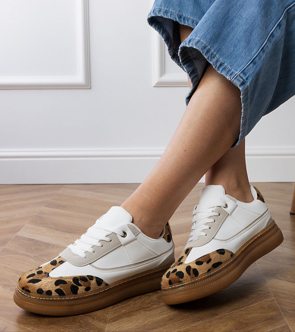 Merisse Panther Accent Sneakers with white and panther print, elevated design, worn casually on wooden floor for daywear style.
