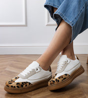 Merisse Panther Accent Sneakers with white and panther print, elevated design, worn casually on wooden floor for daywear style.
