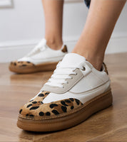Merisse Panther Accent Sneakers with white profile, panther print detail, heightened platform on a wooden floor