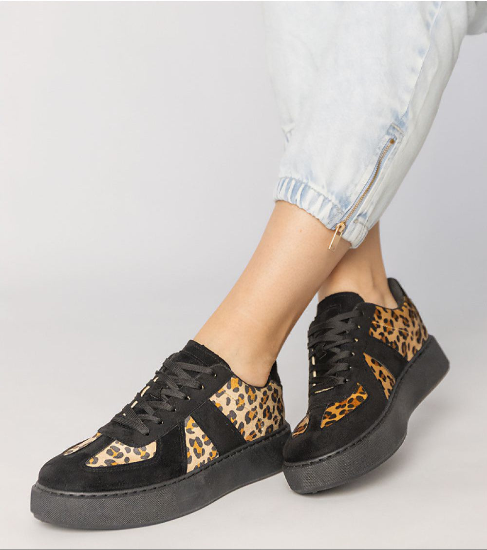 Tirella Patterned Platform Sneakers in white-on-panther motif, worn with rolled-up jeans, showcasing bold and contemporary design.