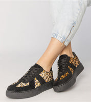 Tirella Patterned Platform Sneakers in white-on-panther motif, worn with rolled-up jeans, showcasing bold and contemporary design.
