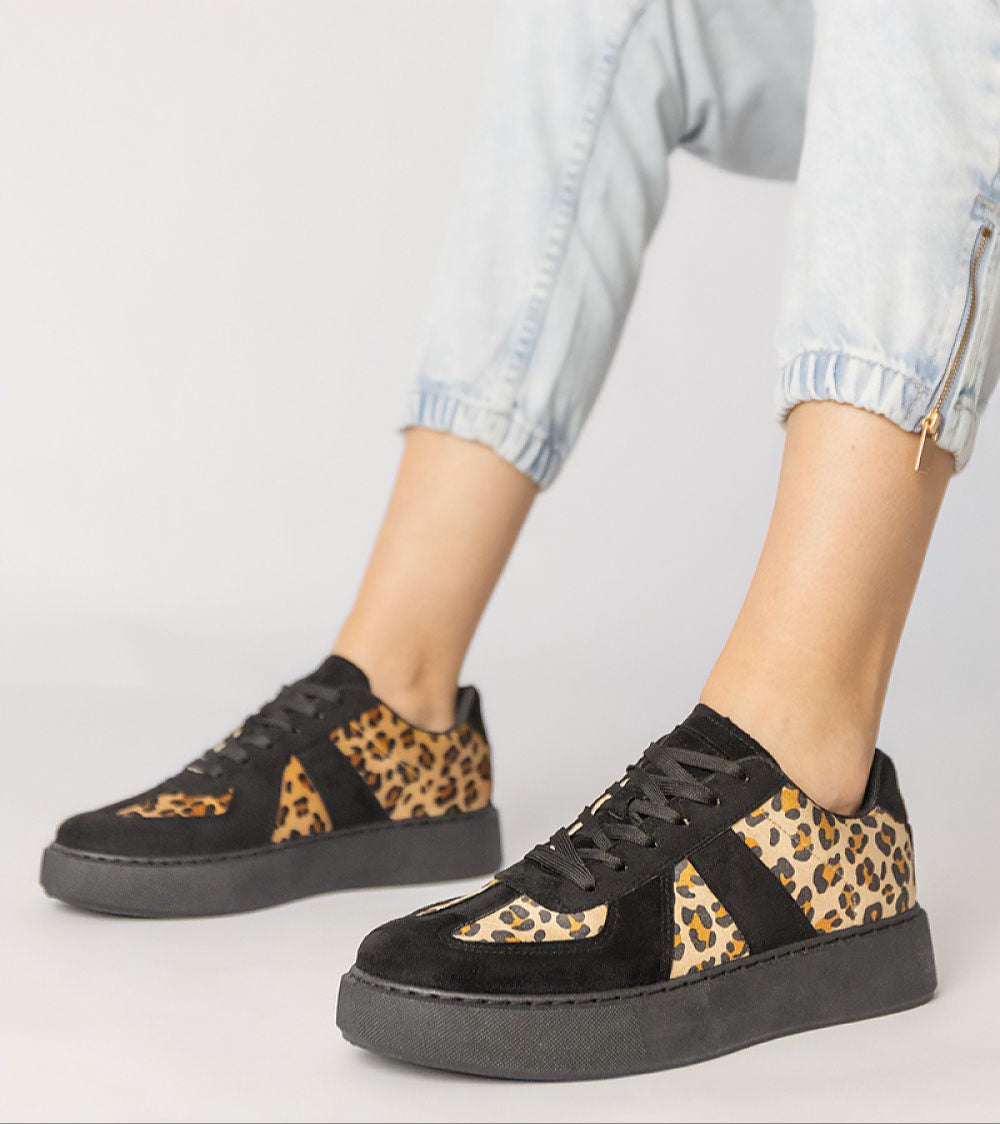 Tirella Patterned Platform Sneakers with panther motif, synthetic leather, lace-up closure, worn with cuffed jeans for modern style.