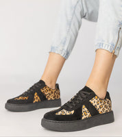 Tirella Patterned Platform Sneakers with panther motif, synthetic leather, lace-up closure, worn with cuffed jeans for modern style.