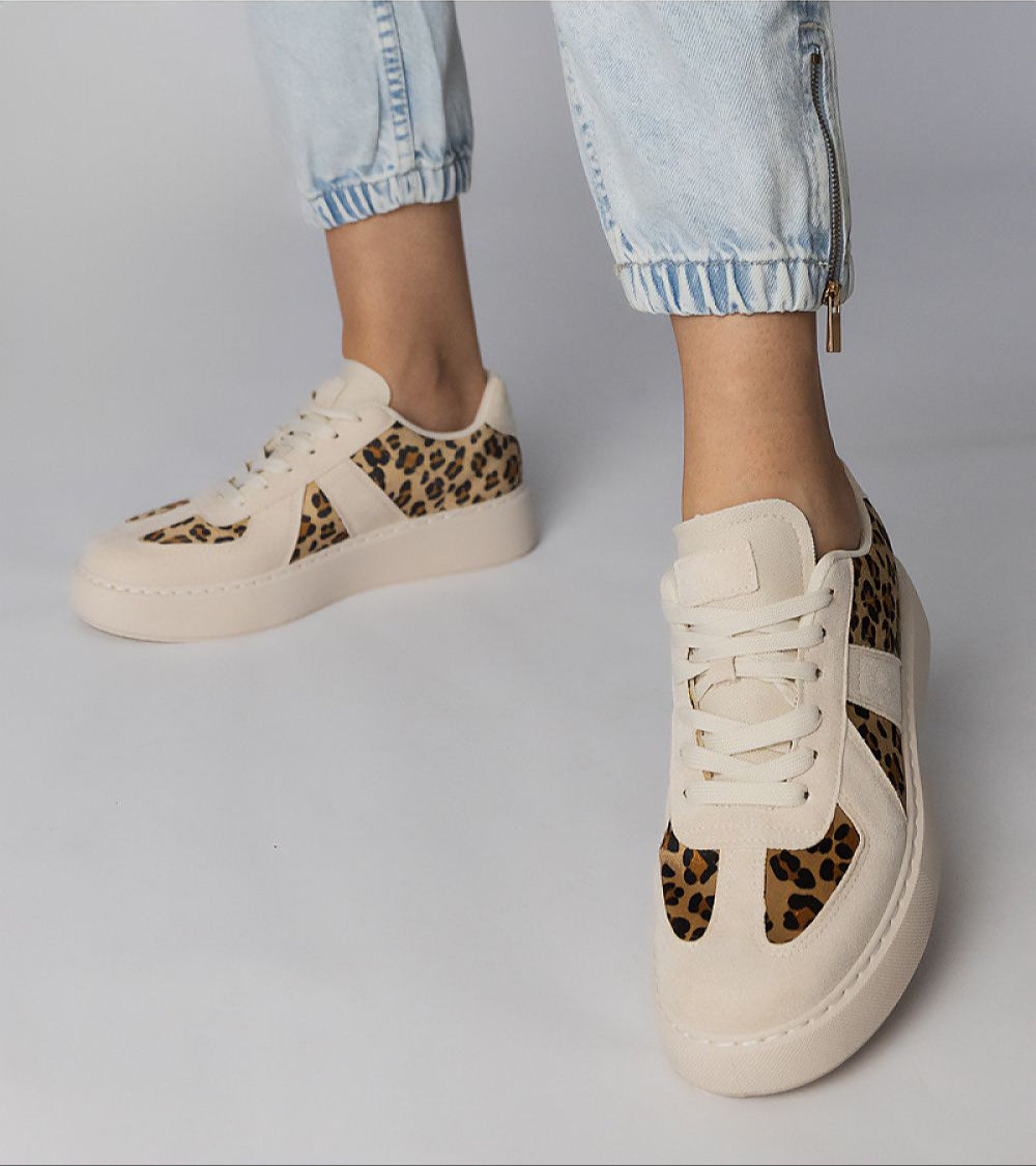 Model wearing Tirella Patterned Platform Sneakers with panther motif, synthetic leather, and lace-up closure for a trendy look.