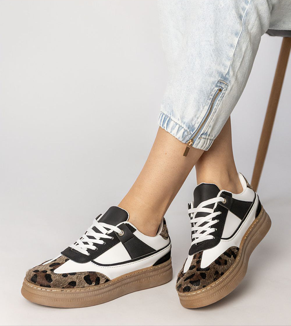 Woman wearing Merisse Panther Accent Sneakers with panther print and elevated platform for daywear elegance and comfort.