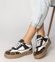 Woman wearing Merisse Panther Accent Sneakers with panther print and elevated platform for daywear elegance and comfort.