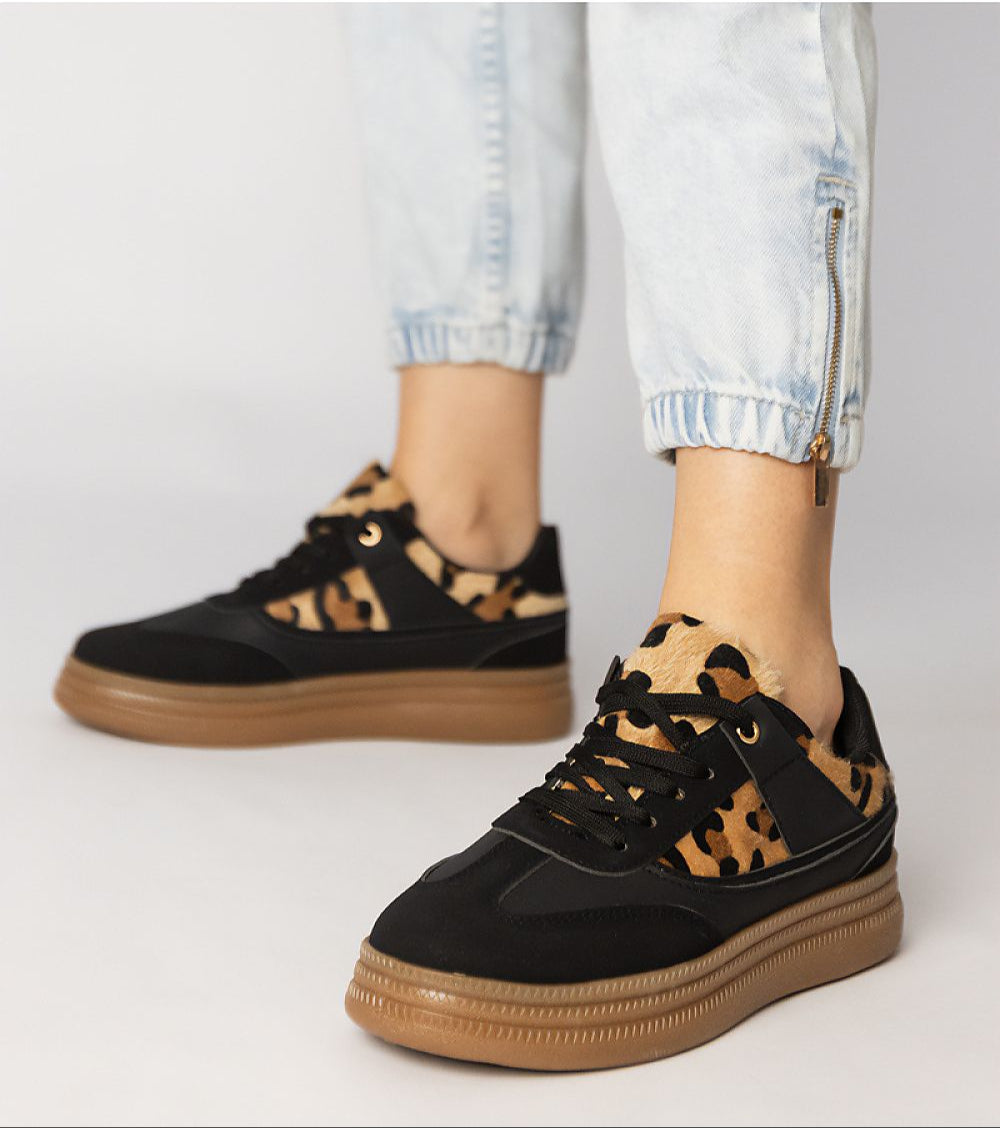 Merisse Panther Accent Sneakers with panther print detail and platform sole worn with light jeans, showcasing bold and elegant style.