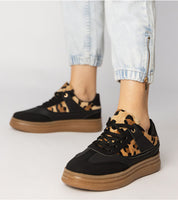 Merisse Panther Accent Sneakers with panther print detail and platform sole worn with light jeans, showcasing bold and elegant style.