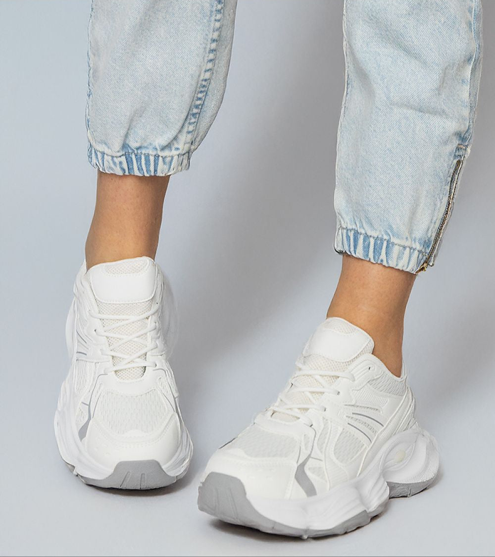 White Thareen Platform Trainers on feet with chunky sole and faux leather, perfect for urban style and everyday comfort.