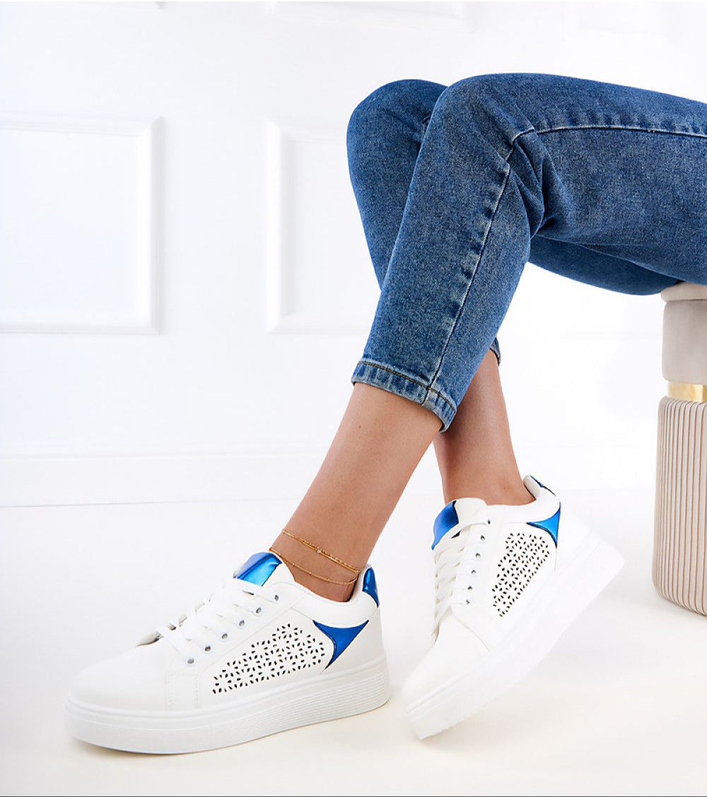Urban platform sneakers with blue accents and perforated eco leather, model wearing denim jeans, showcasing modern footwear design.