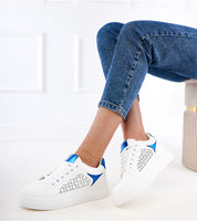 Urban platform sneakers with blue accents and perforated eco leather, model wearing denim jeans, showcasing modern footwear design.