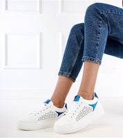 Person wearing Alnora Urban Platform Sneakers with blue accents and elevated sole, showcasing urban style and comfort for city life.