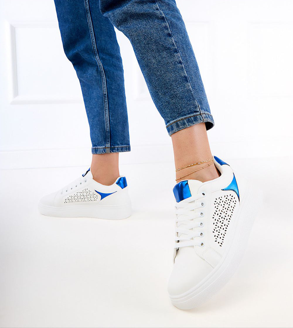 Person wearing Alnora Urban Platform Sneakers with blue accents and jeans, demonstrating modern urban footwear style.