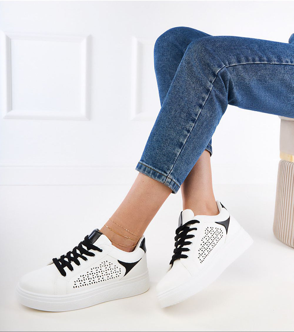 Person wearing Alnora Urban Platform Sneakers with subtle blue accents and eco leather, ideal for dynamic city life.