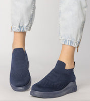 Navy Shadowknit Slip-On Sock Sneakers with stretch-knit upper, firm platform sole, and sleek design, ideal for urban style.