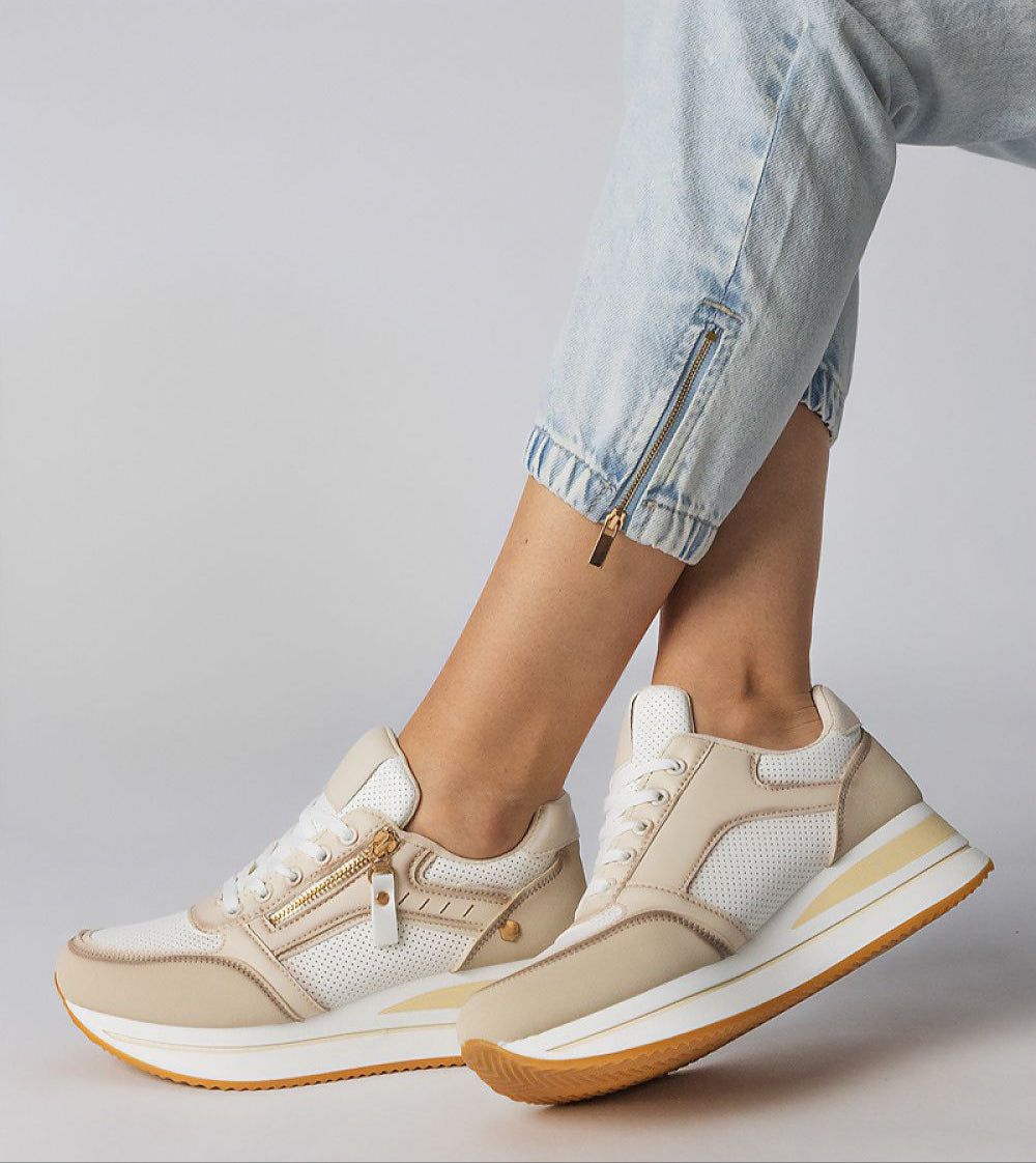Stylish beige and white platform sneakers with side zipper, worn with light jeans, showcasing casual yet trendy fashion.