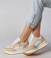 Stylish beige and white platform sneakers with side zipper, worn with light jeans, showcasing casual yet trendy fashion.