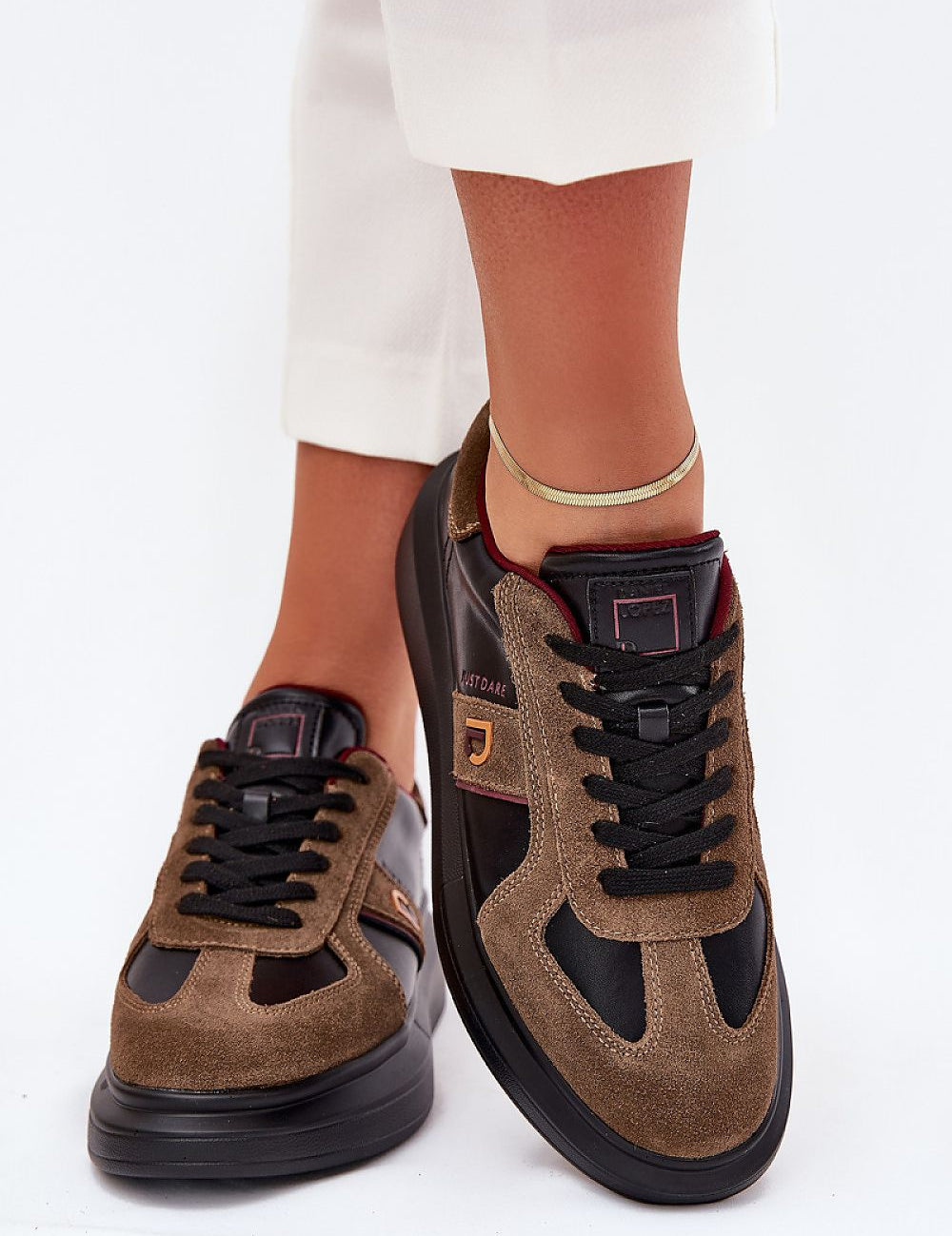 Woman wearing Caravelle Mixed-Leather Sneakers with platform sole and memory foam insole, showcasing suede and leather design.