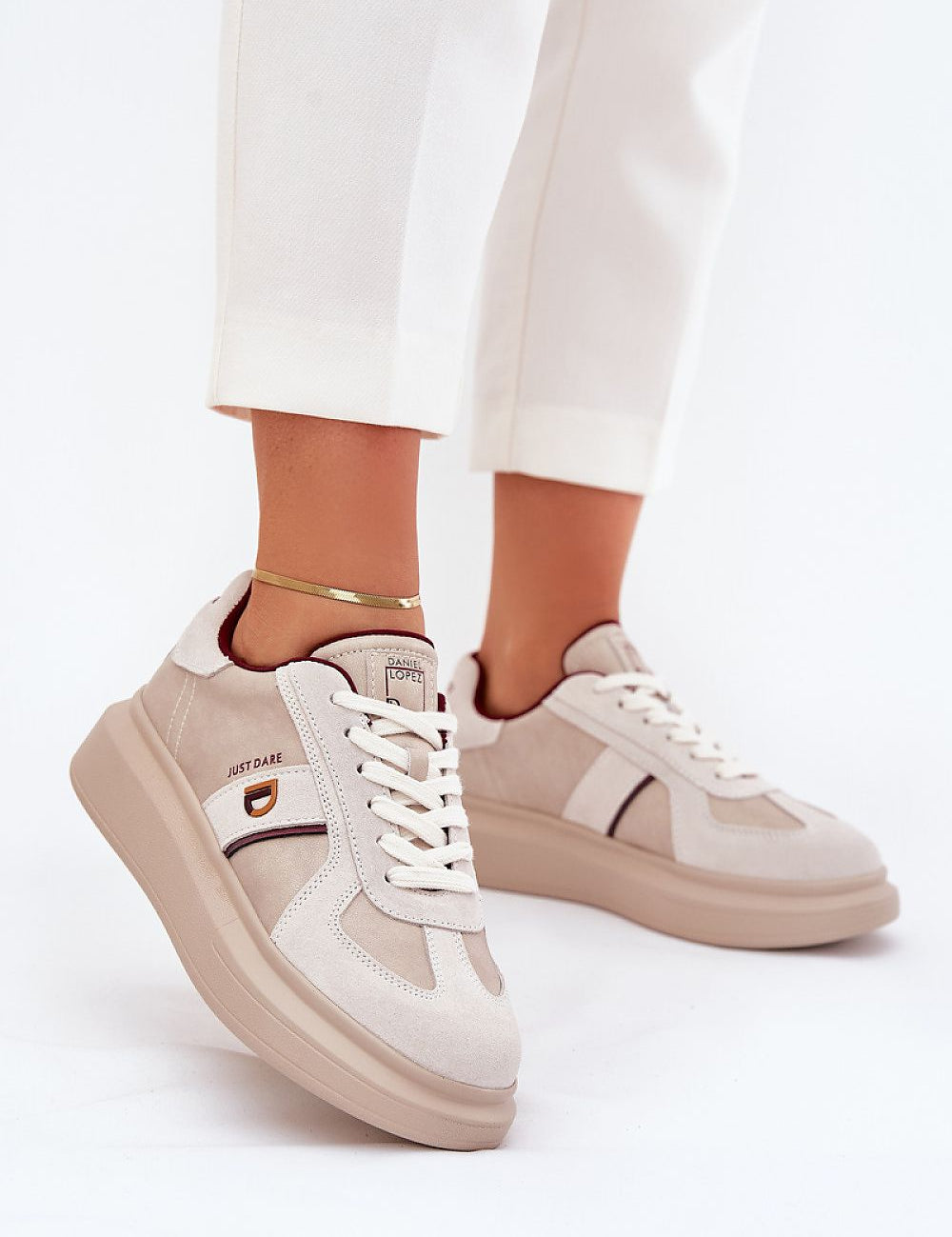 Caravelle mixed-leather platform sneakers with suede accents and elevated sole, worn with white pants for a chic look.